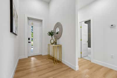 Bright and welcoming entryway featuring modern finishes and a seamless flow into the living space.