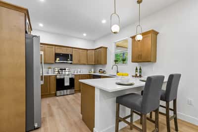 Modern kitchen featuring sleek cabinetry, stainless steel appliances, and an inviting breakfast bar for casual dining.