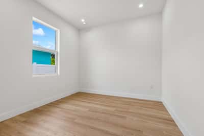 Bright and spacious room featuring large windows and modern flooring, perfect for various uses.