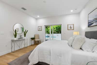 Bright and inviting bedroom featuring modern decor, natural light, and direct access to the outdoor space.