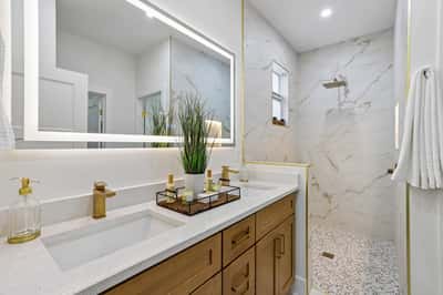 This modern bathroom features sleek fixtures, a spacious shower, and a bright, inviting atmosphere.