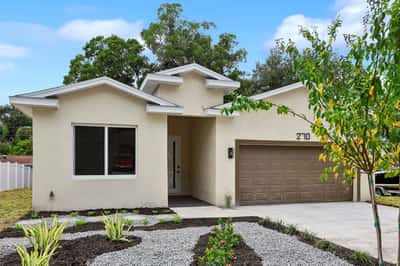This modern home features a spacious layout, a two-car garage, and attractive landscaping for outdoor enjoyment.