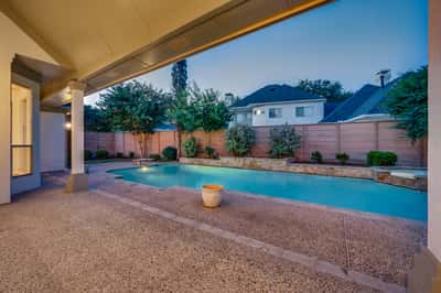 Discover a private outdoor oasis featuring a spacious pool and tranquil landscaping, perfect for relaxation and entertainment.