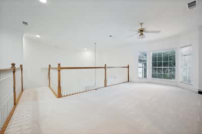 Spacious open area featuring unique architecture and ample natural light, perfect for versatile living options.