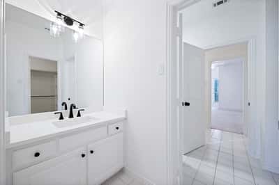 Bright and inviting bathroom featuring modern fixtures and a spacious layout, perfect for everyday comfort.