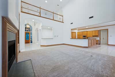 Spacious open-concept living area features high ceilings, ample natural light, and a seamless flow to the kitchen.