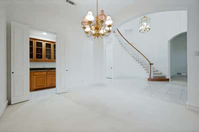 Spacious entryway featuring bright open areas, a graceful staircase, and quality finishes throughout the home.