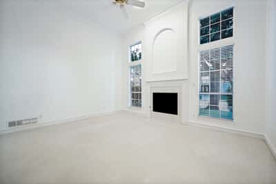 Spacious living area featuring abundant natural light and large windows, ideal for personalized design.