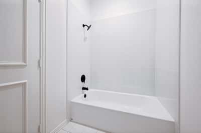 Modern bathroom featuring a clean design with a spacious tub and sleek fixtures, perfect for relaxation.