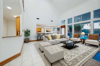 Spacious living area features high ceilings, large windows, and a welcoming layout perfect for entertaining.