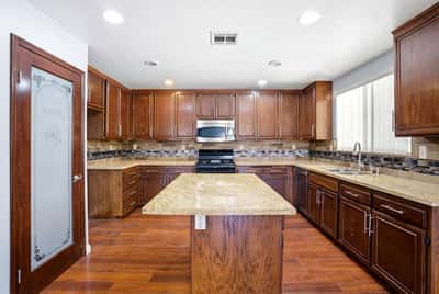 Modern kitchen featuring ample cabinetry, stainless steel appliances, and a spacious island for versatile use.