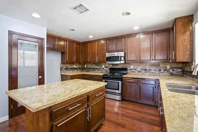 Spacious kitchen featuring rich wood cabinetry, modern appliances, and ample counter space for cooking and entertaining.