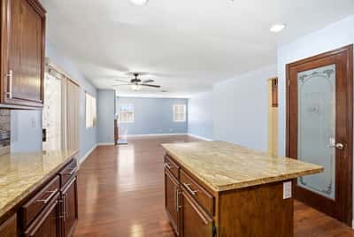 Spacious open-concept living area with a modern kitchen island and abundant natural light.
