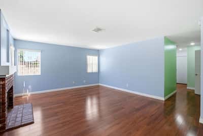 Bright, open living space featuring fresh paint and hardwood floors, ideal for your personal touch.