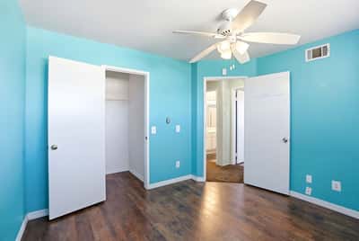 Bright, airy bedroom featuring a refreshing blue color scheme and convenient access to bathroom facilities.