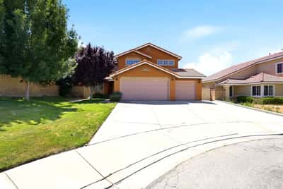 Spacious two-story home with double garage, set on a quiet cul-de-sac surrounded by lush landscaping.