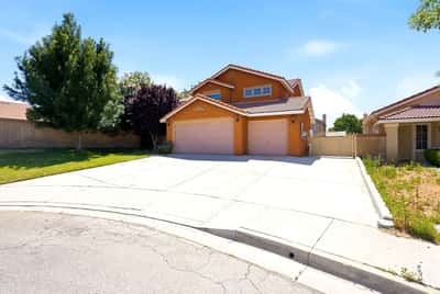 Spacious home featuring a large driveway, ample yard space, and a quiet cul-de-sac location.