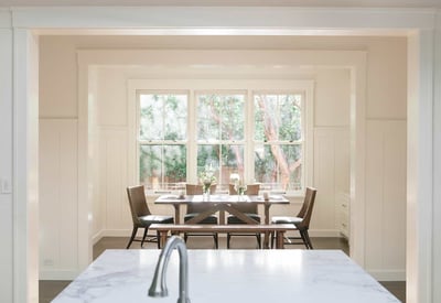 Bright and inviting dining area with large windows, perfect for enjoying meals and natural light.