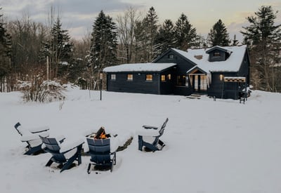 Cozy winter retreat featuring a fire pit, surrounded by snow-covered landscapes and wooded privacy.