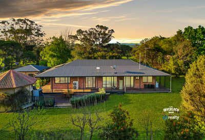 Spacious home set on lush grounds, featuring expansive outdoor areas and stunning views of the landscape.