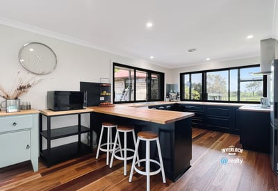 Bright and functional kitchen featuring modern appliances, ample counter space, and scenic views through expansive windows.