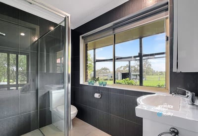 Bright bathroom featuring modern fixtures and scenic views, perfect for relaxation and comfort.