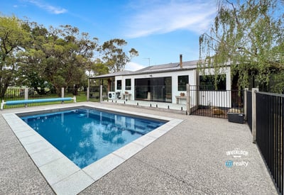 This spacious property features a large pool and versatile outdoor space, ideal for entertaining and relaxation.