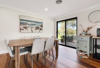 Bright dining area featuring large windows, showcasing views of the outdoors and modern design elements.