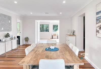 Spacious open-concept living area featuring a modern dining space and abundant natural light throughout.