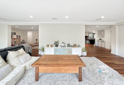 Spacious living area with modern design, featuring abundant light and seamless flow to adjacent rooms.