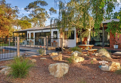 This inviting home features a spacious outdoor area with landscaped gardens and a relaxing poolside retreat.