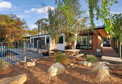 Discover this modern home featuring an inviting outdoor space, pool, and beautiful landscaping for relaxed living.