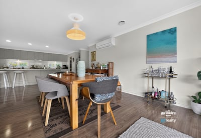 Spacious dining area features modern decor and natural light, perfect for entertaining or family gatherings.