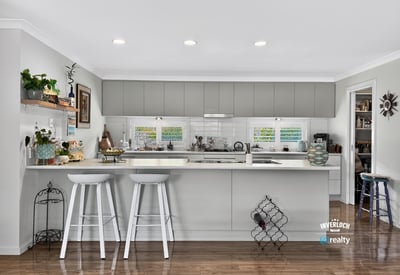 Modern kitchen featuring sleek cabinetry, ample natural light, and a functional open layout for entertaining.