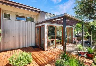 Discover a modern outdoor space featuring a spacious deck and abundant natural light ideal for gatherings.