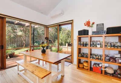 Bright dining space featuring natural light, an open layout, and direct access to a lush outdoor area.