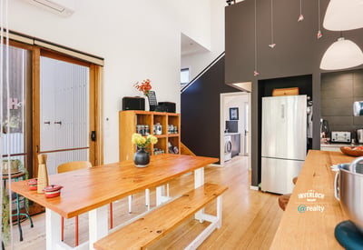 Modern kitchen with open layout, featuring natural light, wooden accents, and a functional design for gatherings.