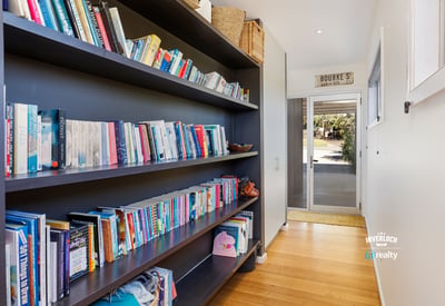 Bright hallway featuring built-in bookshelves, perfect for displaying your favorite reads and personal touches.