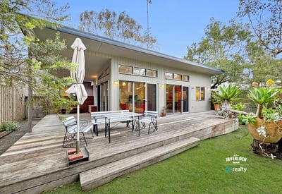 Bright, open-concept home featuring expansive outdoor living space and lush landscaping, ideal for entertaining.