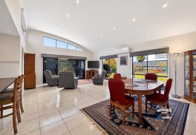 Bright and spacious living area featuring large windows, comfortable seating, and a seamless outdoor transition.