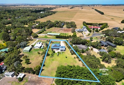Spacious property with expansive outdoor space, surrounded by lush greenery and scenic rural views.