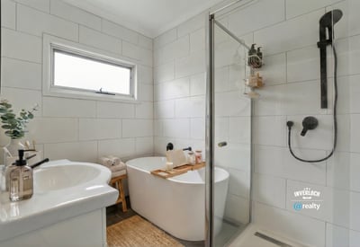 Modern bathroom featuring a sleek freestanding tub, spacious walk-in shower, and contemporary fixtures for a refreshing experience.