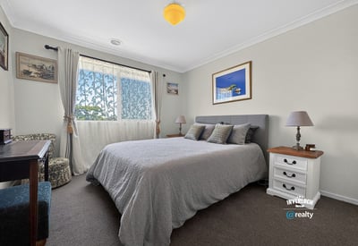 Spacious bedroom featuring natural light, cozy furnishings, and a tranquil atmosphere ideal for relaxation.