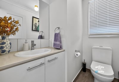Well-appointed bathroom featuring modern fixtures and ample natural light for a refreshing atmosphere.