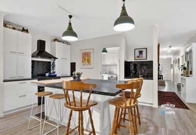 Modern kitchen featuring a spacious island, sleek cabinetry, and ample natural light flowing throughout the open layout.