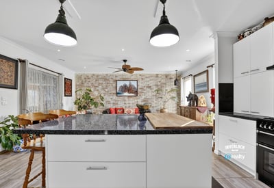 Inviting open-concept kitchen and living area featuring modern finishes and a cozy atmosphere for gatherings.