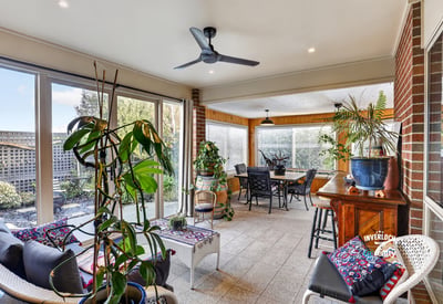 Bright and spacious sunroom featuring ample natural light, perfect for relaxing and entertaining.