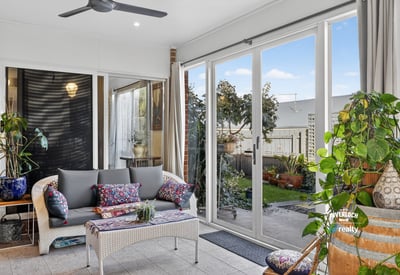 Bright and airy sunroom featuring large windows, perfect for relaxation and enjoying views of the garden.