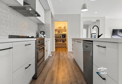 Modern kitchen featuring sleek cabinetry, abundant natural light, and an open layout perfect for entertaining.