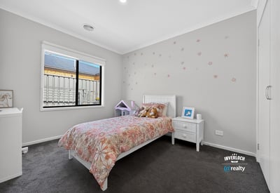 Bright and welcoming bedroom featuring modern decor and ample natural light, perfect for relaxation and rest.